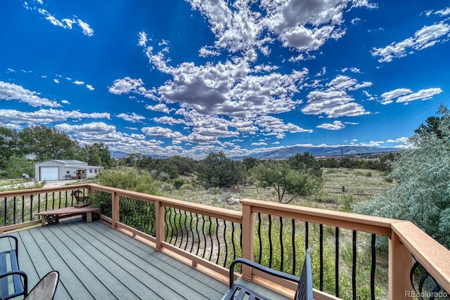 deck with a garage and an outdoor structure