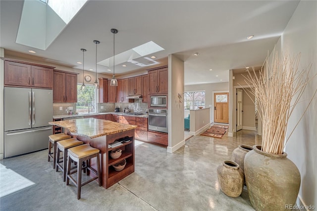 322 W Park Ave, Salida, CO 81201 - kitchen with appliances with stainless steel finishes, a skylight, a sink, backsplash, and a center island