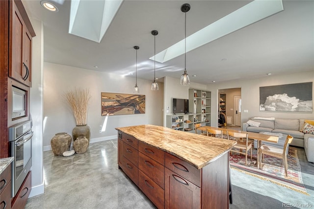 322 W Park Ave, Salida, CO 81201 - kitchen with appliances with stainless steel finishes, a skylight, open floor plan, baseboards, and a center island