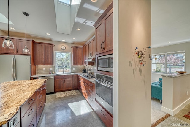 322 W Park Ave, Salida, CO 81201 - kitchen with stainless steel appliances, backsplash, decorative light fixtures, light stone countertops, and recessed lighting