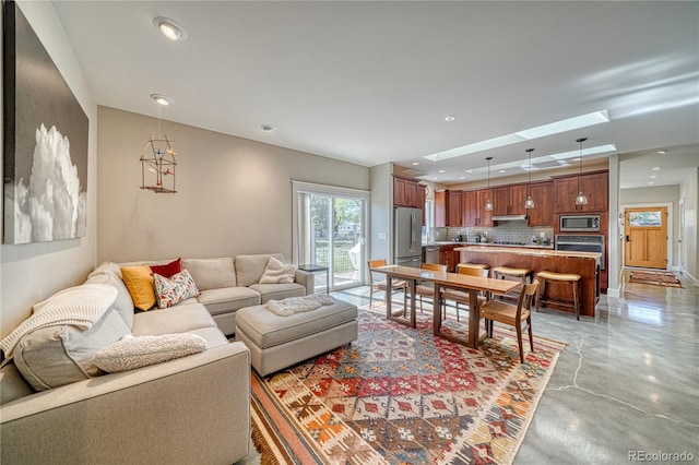 322 W Park Ave, Salida, CO 81201 - living area with recessed lighting, finished concrete flooring, and a skylight