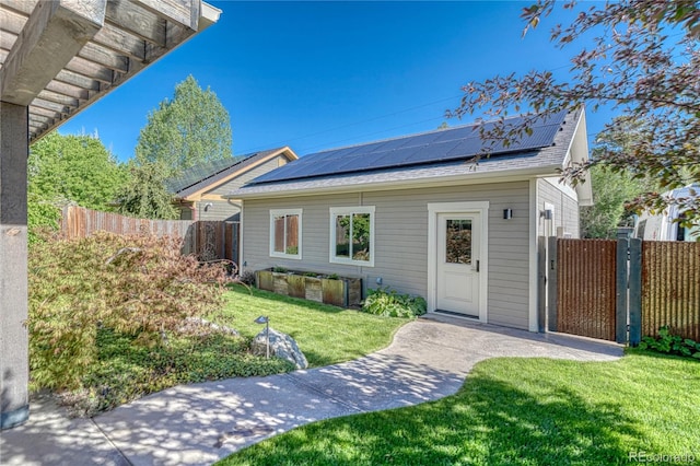 322 W Park Ave, Salida, CO 81201 - view of front of property with solar panels, a shingled roof, and a gate