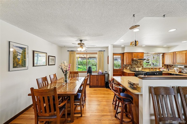 7590 E Easter Pl, Centennial, CO 80112 - dining area with a textured ceiling, light wood-type flooring, healthy amount of natural light, ceiling fan, and recessed lighting