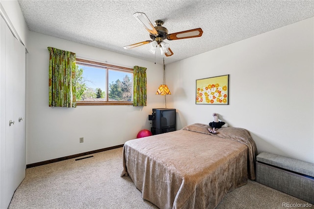 7590 E Easter Pl, Centennial, CO 80112 - bedroom with carpet floors, a textured ceiling, a closet, baseboards, and ceiling fan