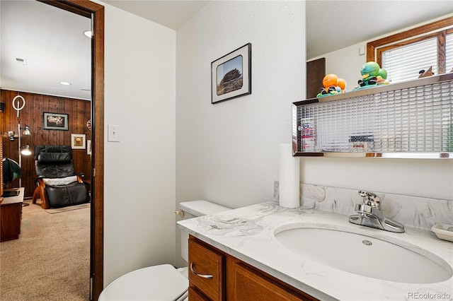 7590 E Easter Pl, Centennial, CO 80112 - bathroom featuring toilet, vanity, and wooden walls
