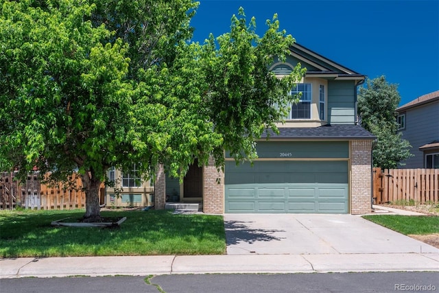 20445 Mitchell Pl, Denver, CO 80249 - obstructed view of property featuring brick siding, driveway, and an attached garage
