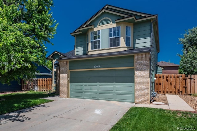 20445 Mitchell Pl, Denver, CO 80249 - traditional-style home with brick siding, concrete driveway, an attached garage, and a gate