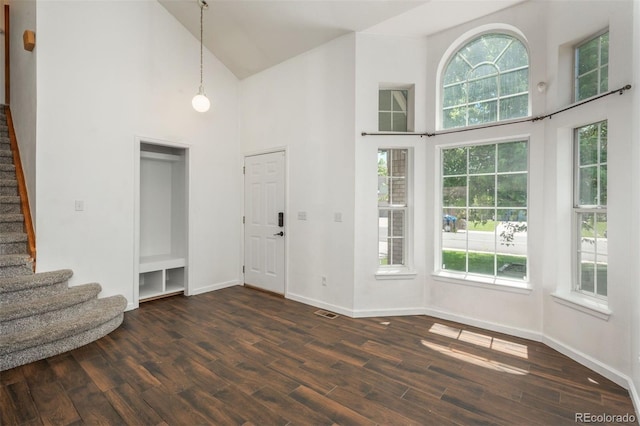 20445 Mitchell Pl, Denver, CO 80249 - entrance foyer featuring high vaulted ceiling, stairs, and dark wood-type flooring