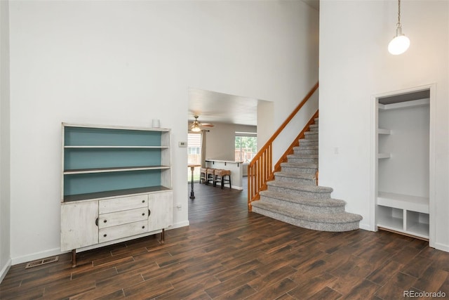 20445 Mitchell Pl, Denver, CO 80249 - unfurnished living room with wood finished floors, stairs, a high ceiling, and a ceiling fan