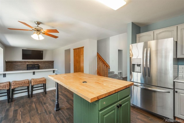 20445 Mitchell Pl, Denver, CO 80249 - kitchen featuring stainless steel fridge with ice dispenser, green cabinetry, wooden counters, a ceiling fan, and dark wood-type flooring