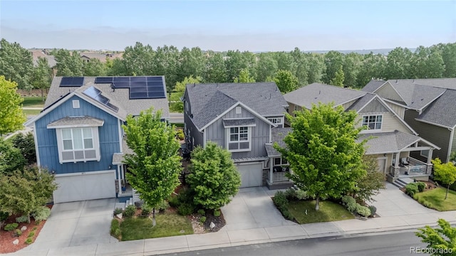 1867 W 137th Ln, Broomfield, CO 80023 - craftsman-style home with concrete driveway, a garage, board and batten siding, roof mounted solar panels, and a residential view