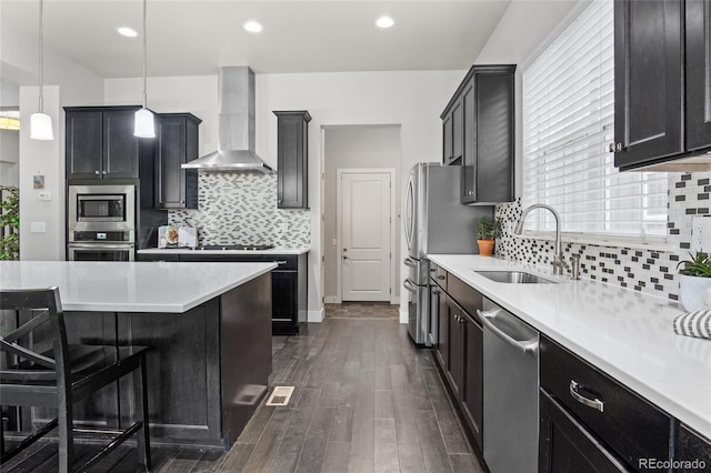 1867 W 137th Ln, Broomfield, CO 80023 - kitchen with wall chimney exhaust hood, stainless steel appliances, dark wood-type flooring, backsplash, and recessed lighting