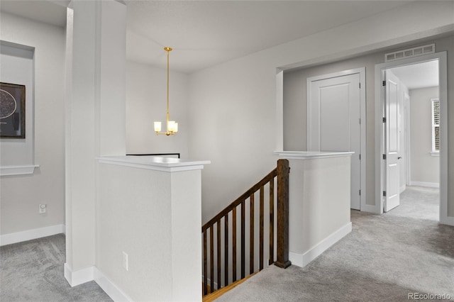 1867 W 137th Ln, Broomfield, CO 80023 - corridor featuring an upstairs landing, carpet flooring, and a chandelier