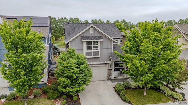 1867 W 137th Ln, Broomfield, CO 80023 - view of front of property with board and batten siding, concrete driveway, roof with shingles, an attached garage, and stone siding