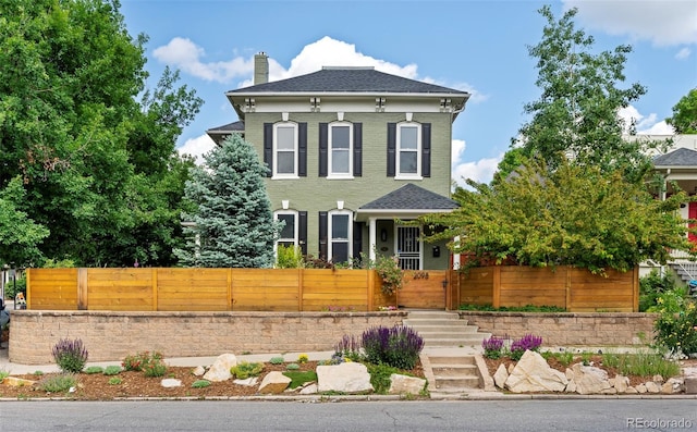 2098 N Clarkson St, Denver, CO 80205 - italianate house with a fenced front yard and a chimney