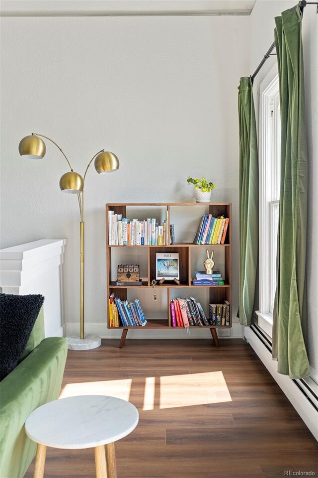 2098 N Clarkson St, Denver, CO 80205 - living area with a baseboard heating unit and wood finished floors