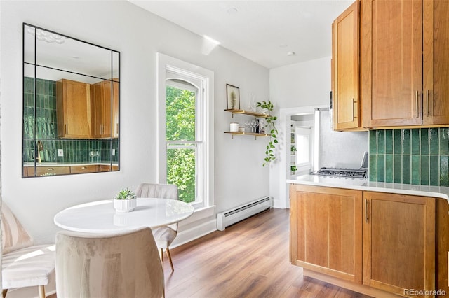 2098 N Clarkson St, Denver, CO 80205 - kitchen featuring a baseboard radiator, light wood-style floors, backsplash, light countertops, and open shelves