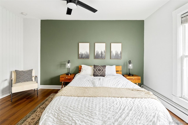 2098 N Clarkson St, Denver, CO 80205 - bedroom with wood finished floors, baseboard heating, baseboards, and a ceiling fan