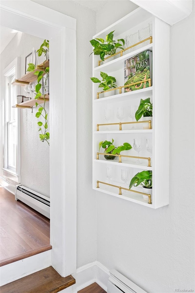 2098 N Clarkson St, Denver, CO 80205 - detailed view of a baseboard radiator, wood finished floors, baseboard heating, and baseboards