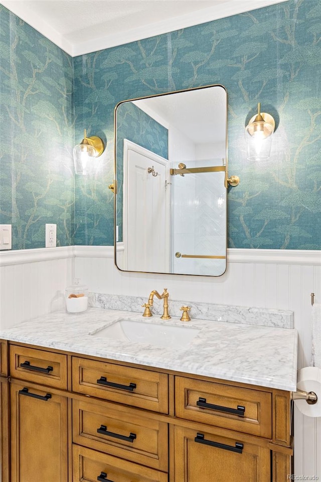 2098 N Clarkson St, Denver, CO 80205 - bathroom with wallpapered walls, vanity, wainscoting, and a shower