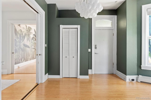 2098 N Clarkson St, Denver, CO 80205 - entryway featuring a chandelier, light wood finished floors, a baseboard radiator, and baseboards