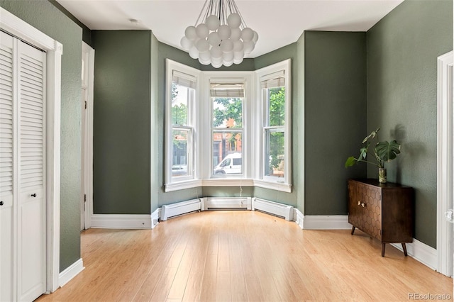 2098 N Clarkson St, Denver, CO 80205 - unfurnished dining area with a chandelier, light wood finished floors, baseboards, baseboard heating, and a textured wall