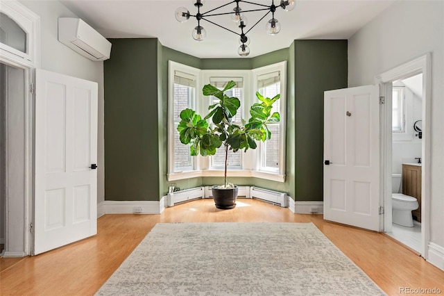 2098 N Clarkson St, Denver, CO 80205 - sitting room with a wall mounted AC, a chandelier, light wood-type flooring, and baseboards