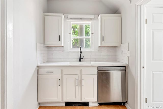 2098 N Clarkson St, Denver, CO 80205 - kitchen featuring stainless steel dishwasher, a sink, tasteful backsplash, and light countertops