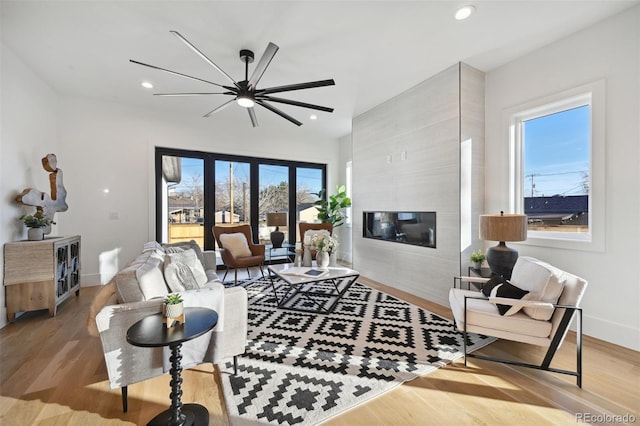 living room featuring light wood-type flooring and plenty of natural light