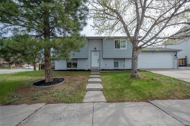 3902 S Uravan St, Aurora, CO 80013 - split foyer home with driveway, a front yard, an attached garage, and brick siding