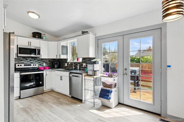 3902 S Uravan St, Aurora, CO 80013 - kitchen featuring appliances with stainless steel finishes, french doors, decorative backsplash, a sink, and white cabinets