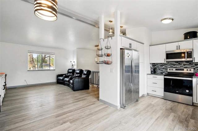 3902 S Uravan St, Aurora, CO 80013 - kitchen featuring appliances with stainless steel finishes, light wood finished floors, tasteful backsplash, white cabinetry, and open floor plan
