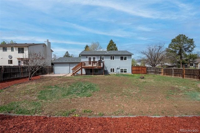 3902 S Uravan St, Aurora, CO 80013 - rear view of house featuring stairway, a wooden deck, and a garage
