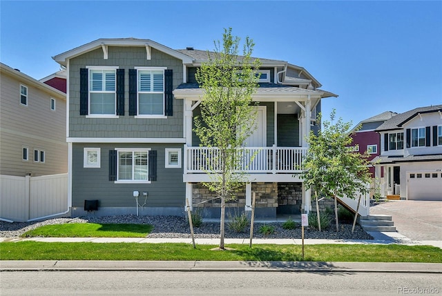 1086 Highlands Dr, Erie, CO 80516 - view of front of property with covered porch, fence, and concrete driveway