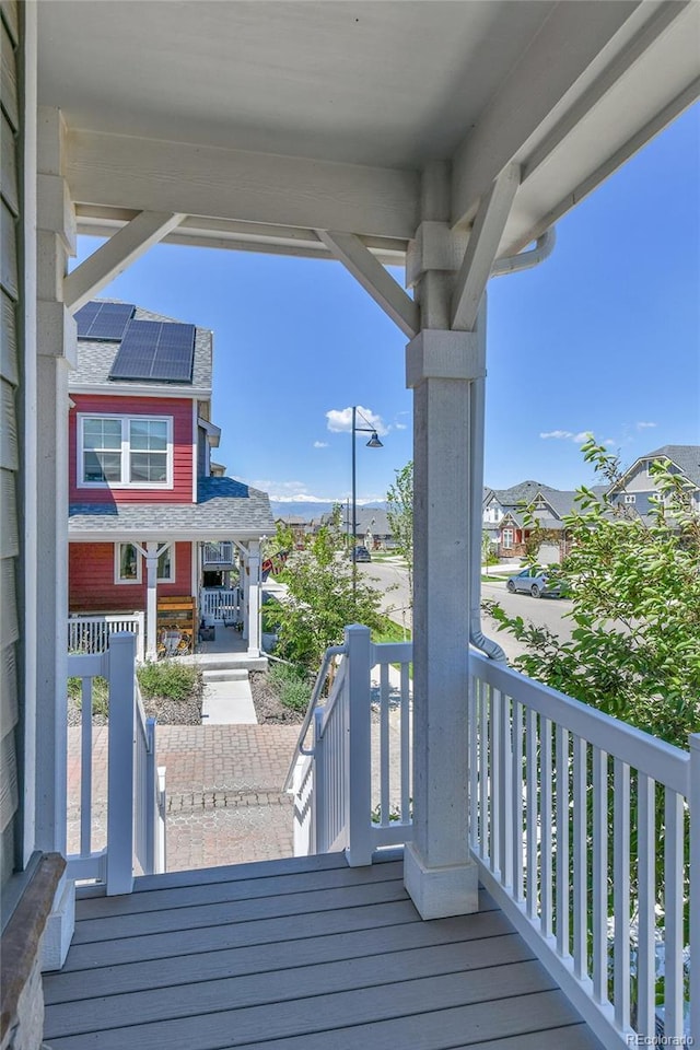 1086 Highlands Dr, Erie, CO 80516 - wooden deck with covered porch and a residential view