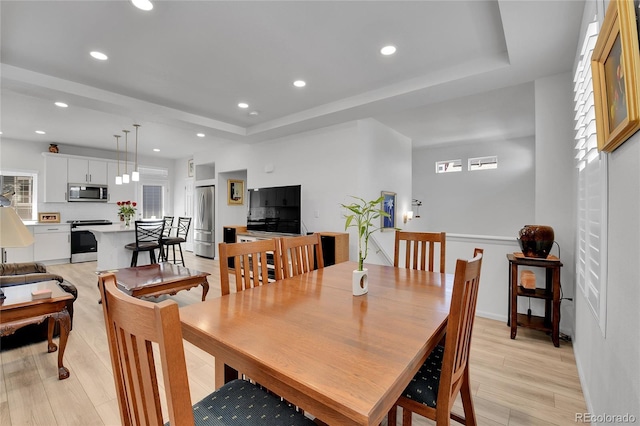 1086 Highlands Dr, Erie, CO 80516 - dining area featuring a raised ceiling, light wood-style floors, healthy amount of natural light, and recessed lighting