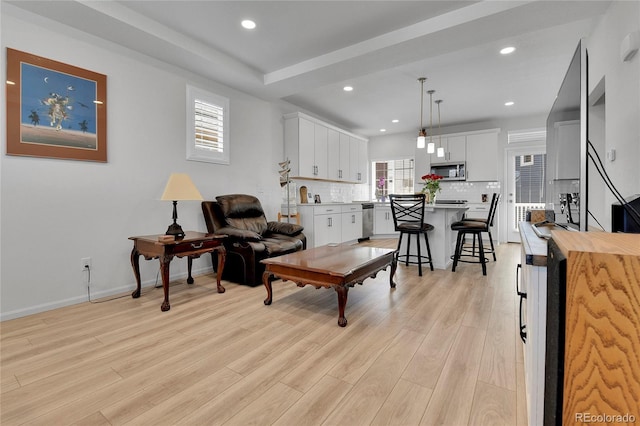 1086 Highlands Dr, Erie, CO 80516 - living room featuring healthy amount of natural light, light wood-style floors, recessed lighting, and baseboards