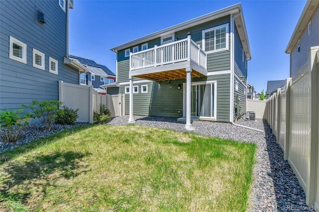 1086 Highlands Dr, Erie, CO 80516 - back of property with central AC, a wooden deck, and an outdoor structure