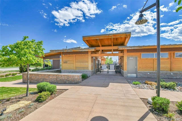 1086 Highlands Dr, Erie, CO 80516 - view of front of house featuring a gate, stone siding, and fence