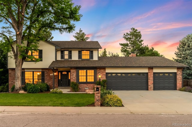 7308 S Steele Cir, Centennial, CO 80122 - traditional-style house featuring brick siding, an attached garage, driveway, and a front lawn