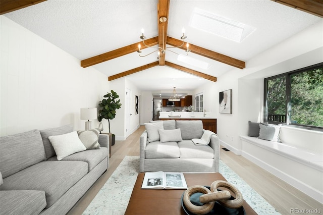 7308 S Steele Cir, Centennial, CO 80122 - living room featuring a skylight, light wood finished floors, and a chandelier