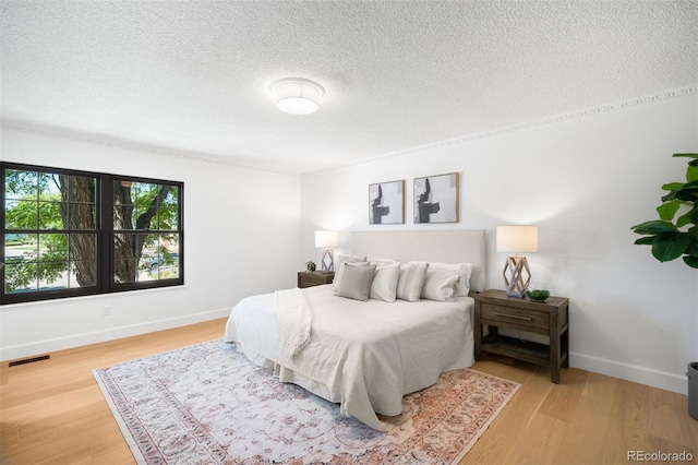 7308 S Steele Cir, Centennial, CO 80122 - bedroom featuring a textured ceiling and light wood finished floors