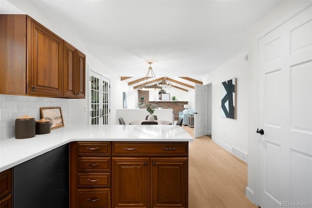7308 S Steele Cir, Centennial, CO 80122 - kitchen featuring a peninsula, dishwasher, light wood-style floors, backsplash, and light countertops