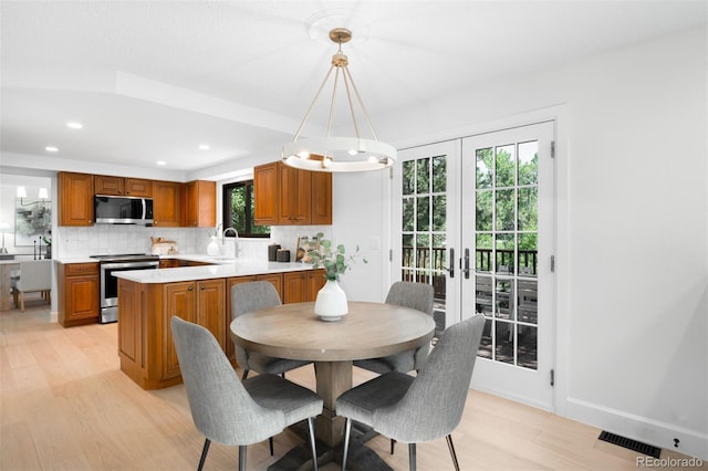 7308 S Steele Cir, Centennial, CO 80122 - dining space featuring light wood finished floors, french doors, and recessed lighting