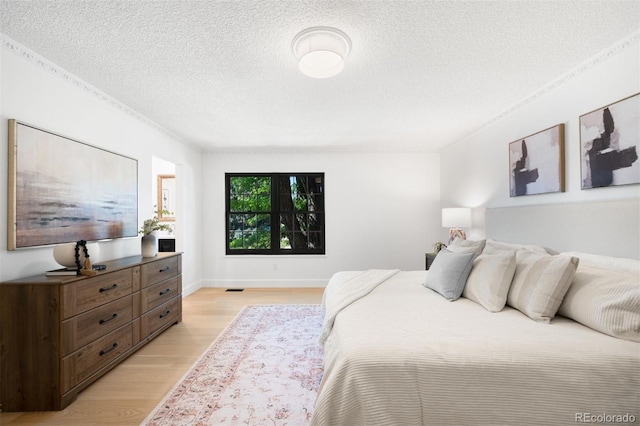 7308 S Steele Cir, Centennial, CO 80122 - bedroom with light wood-style floors and a textured ceiling