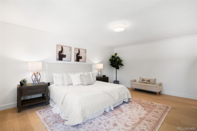 7308 S Steele Cir, Centennial, CO 80122 - bedroom with crown molding, wood finished floors, and a textured ceiling