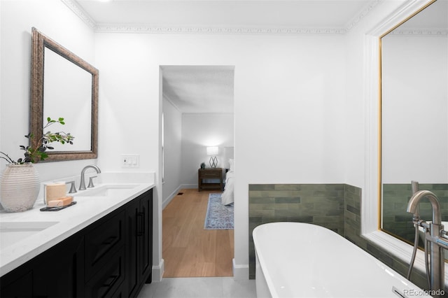 7308 S Steele Cir, Centennial, CO 80122 - full bath featuring a soaking tub, double vanity, and wood finished floors