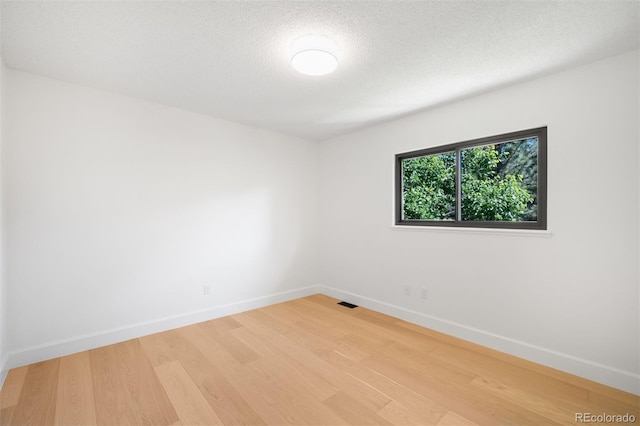 7308 S Steele Cir, Centennial, CO 80122 - empty room with wood finished floors and a textured ceiling