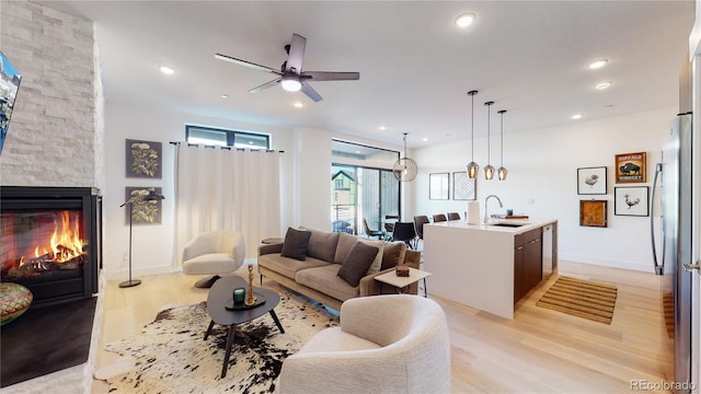 930 Blue River Pkwy Unit 622, Silverthorne, CO 80498 - living area featuring light wood-type flooring, a ceiling fan, a fireplace, recessed lighting, and baseboards