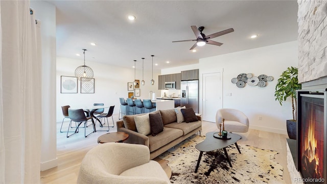 930 Blue River Pkwy Unit 622, Silverthorne, CO 80498 - living room with light wood-style floors, ceiling fan, recessed lighting, and a large fireplace